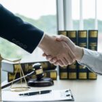 Handshake after Lawyer providing legal consult business dispute service to the man at the office
